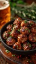 an atractive and tastefull image of meatballs portion and pint of beer together