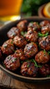 an atractive and tastefull image of meatballs portion and pint of beer together