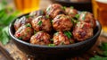 an atractive and tastefull image of meatballs portion and pint of beer together