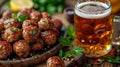 an atractive and tastefull image of meatballs portion and pint of beer together