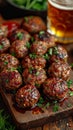 an atractive and tastefull image of meatballs portion and pint of beer together