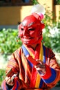Atsara Joker wearing red traditional Bhutanese dress entertain