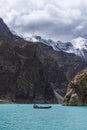 Attabad lake and rocky mountain with local boat in Pakistan