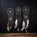 3 attache dWhite dream catcher with feather hanging at black wooden background