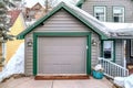 Attached garage of a house with gable roof and gray cladding on exterior wall Royalty Free Stock Photo