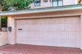 Attached garage of San Dego California home with white door and brick driveway Royalty Free Stock Photo