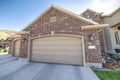 Attached three-car garage of a house with red bricks exterior Royalty Free Stock Photo