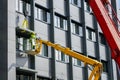 Attaching the finishing element of the house facade using a scissor lift