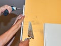 Attaching a part of a plaster board on a wall