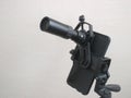 Attachment between monocular telescope and smartphone on a tripod