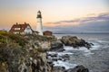 Attacked by waves an active lighthouse on the rocky shore of the Atlantic Ocean continues to point the way for sailors in the
