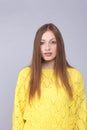 Attactive red haired woman with yellow pullover