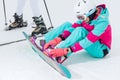 Attarctive girl preparing the equipmnet for snowboarding Royalty Free Stock Photo