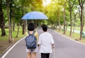 Attempt elderly asian women walking to do workout with stick at public park,Daughter take care and support