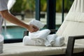 attendant placing fresh towels on spa lounge chair Royalty Free Stock Photo