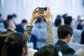 Attendees use smartphone photography in the seminar room