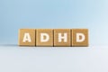 Attention deficit hyperactivity disorder ADHD. Text abbreviation on wood cubes/blocks on light blue background