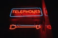 Attention getting neon sign with arrow for telephone