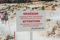 Attention sign near a descent to Nisyros volcano crater. Royalty Free Stock Photo