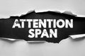 ATTENTION SPAN phrase beneath torn paper texture, concept about focus, psychology, learning, education, and mental ability with Royalty Free Stock Photo