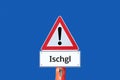 Attention warning sign Ischgl on blue background in german