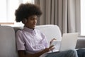 Attentive African student guy in headphones studying online using laptop Royalty Free Stock Photo