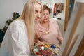 Portrait of busy woman working in art studio