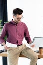 Attentive businessman holding documents while sitting