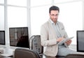 Attentive businessman uses a digital tablet in a modern office. Royalty Free Stock Photo