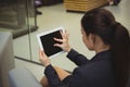 Attentive businesswoman sitting on sofa and using digital tablet Royalty Free Stock Photo