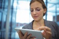 Attentive businesswoman using digital tablet in corridor Royalty Free Stock Photo