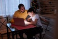 Attentive and careful father help son to study