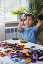 Attentive cute baby boy learning geometric figure shapes playing multicolored wooden construction Royalty Free Stock Photo