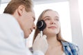 Attentive dermatologist exploring teenager skin in the hospital