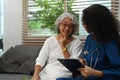 Attentive doctor instructing about treatment, giving professional consultation to elder woman. Home health care service