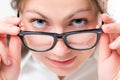 Attentive girl watching glasses having lowered