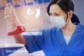 Attentive lab worker frowning while looking at the red liquid in the bottle Royalty Free Stock Photo