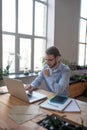 Attentive man with glasses looking at laptop. Royalty Free Stock Photo