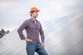 Attentive man in helmet near gray surface outdoors