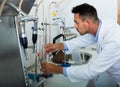 attentive man making tests in wine manufactory laboratory