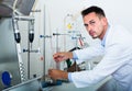 Attentive man making tests in wine manufactory laboratory