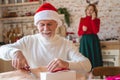 Attentive mature male wrapping presents for grandchildren