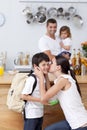 Attentive mother giving school lunch to her son