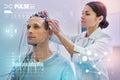 Attentive nurse touching wires while checking them before making EEG