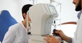 Attentive optometrist examining female patient on slit lamp Royalty Free Stock Photo