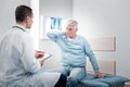 Attentive physician communicating with retirement