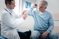 Attentive physician examining sick arm