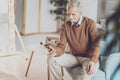 Attentive retirement reading news on his gadget