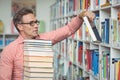 Attentive school teacher holding book in library