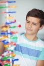 Attentive schoolboy experimenting molecule model in laboratory